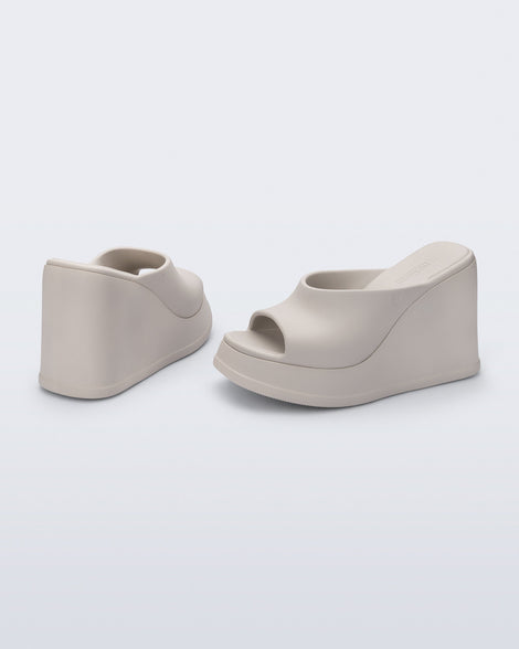 Back and angled view of a pair of beige Free Slip platform wedge heels