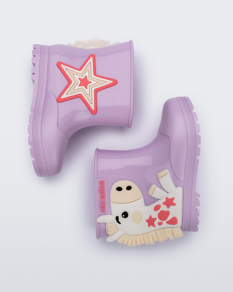 Side view of a pair of white Welly Wonderland baby boots with orange pony on one shoe and star on the other