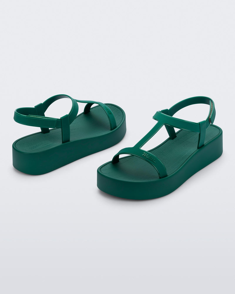 Back and angled view of a pair of green Sun Capri Platform sandals with ankle straps