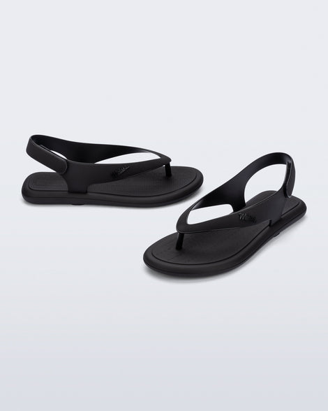 Side and angled view of a pair of black Sun Samba thong sandals