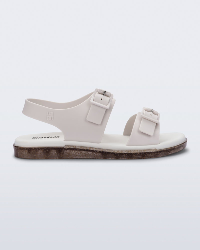 Side  view of a beige Wave Sandal with two straps with buckles and a back strap
