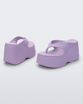 Back and angled view of a pair of lilac Free Thong  Wedge Platform heels