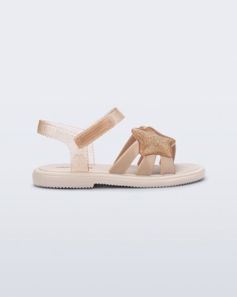 Side view of a beige Hip Sky baby sandal with a glitter beige star on top