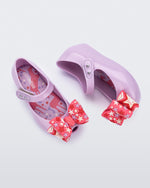 Top and side view of a pair of lilac with pink star patterned bow Ultragirl Wonderland baby flats