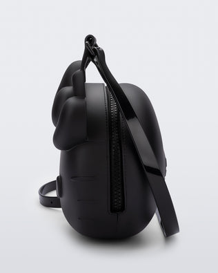 Side view of a black Hello Kitty + Friends Cute Bag with the face of Hello Kitty