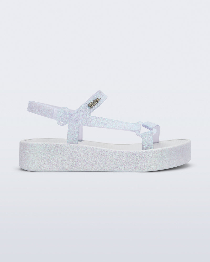 Side view of a white glitter Sun Downtown Platform sandal