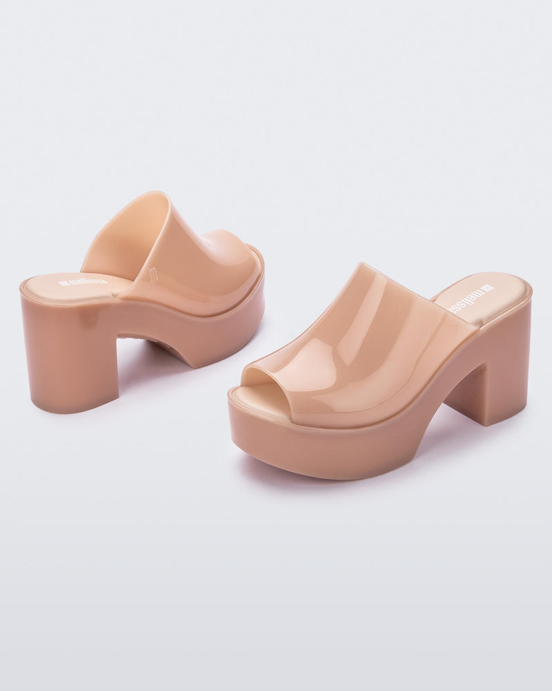 Angled view of a pair of pink Mule Hype heel platforms