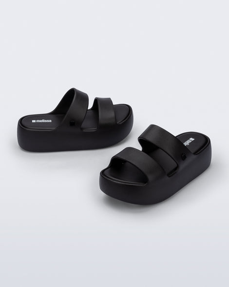 Angled and side view of a pair of black Free Line Platform slides