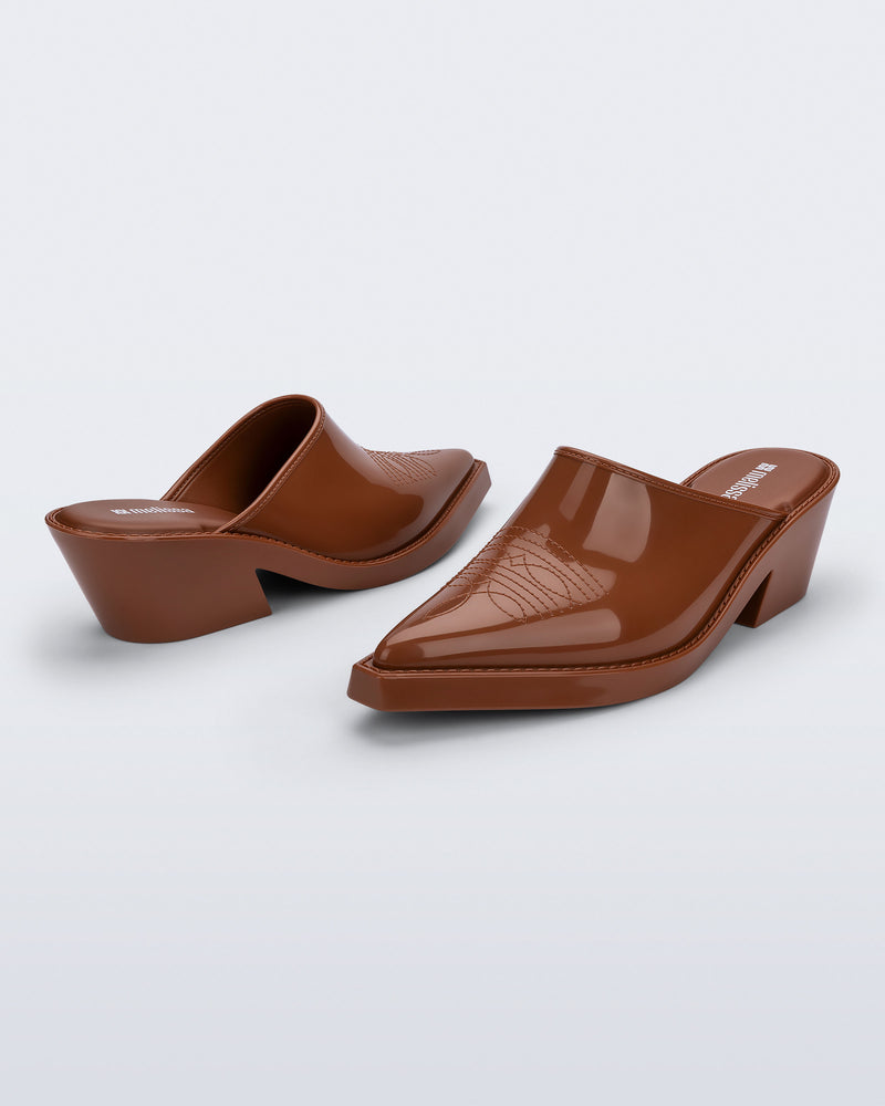 Side and angled view of a pair of brown Texas Mule heels