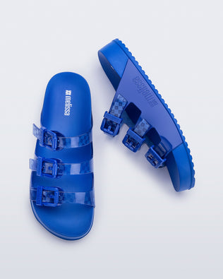 Top and side view of a pair of blue Cozy Stripes slides