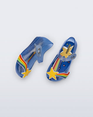 Top and side view of a pair of glitter blue Ultragirl Colors baby flats with yellow star and rainbow on top