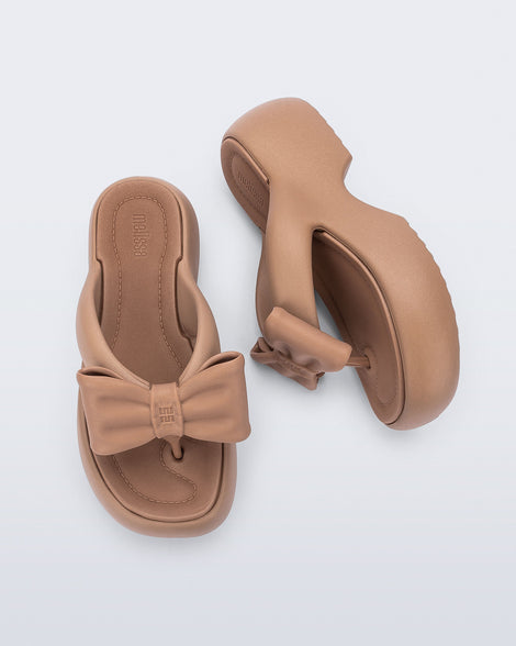 Side and top view of a pair of brown Free Fuzzy Platform flip flops