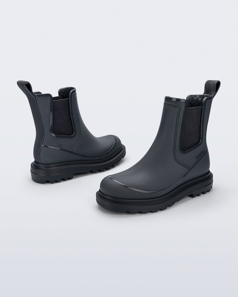 Side angled views of a pair of grey Noir Boots with black soles