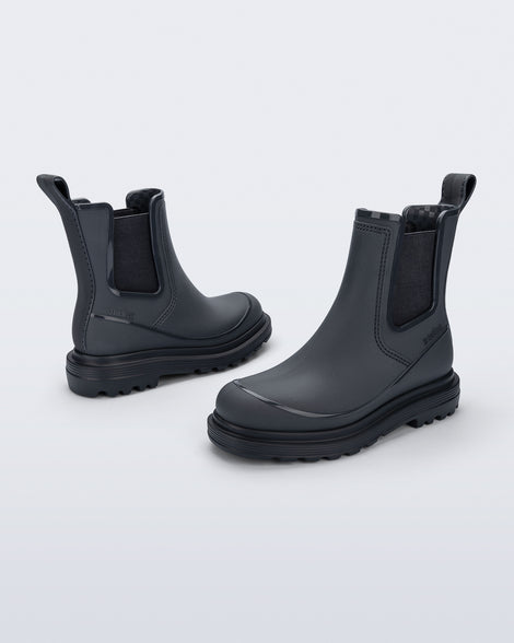 Side angled views of a pair of grey Noir Boots with black soles