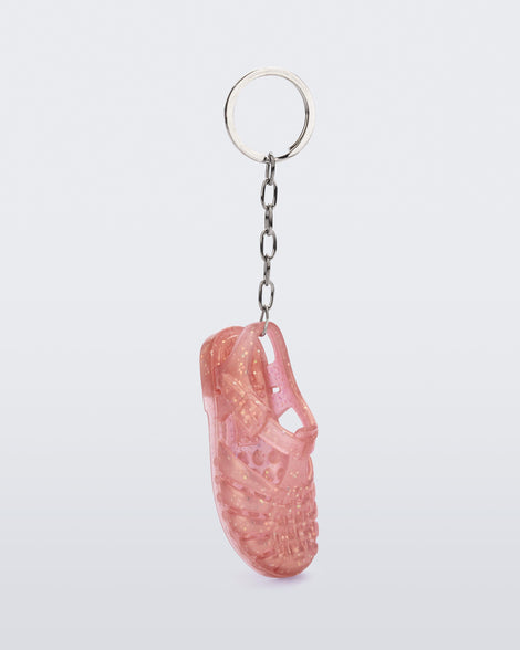 Angled view of glitter pink Possession keyring
