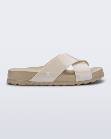 Side view of a beige Cozy Cross sandal with crisscross top straps