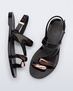 Top  and side view of a pair of black Iris sandals with copper upper embellishments