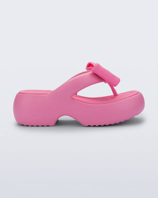 Side view of a pink Free Fuzzy Platform flip flop 