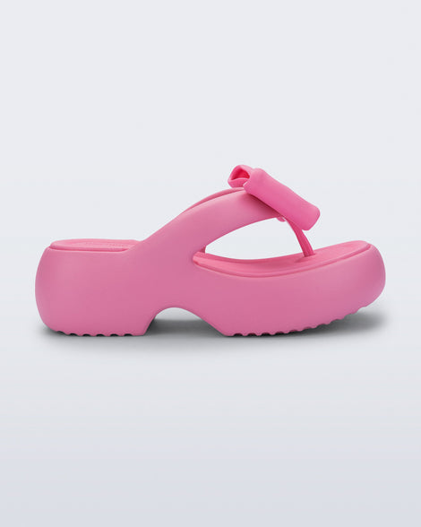Side view of a pink Free Fuzzy Platform flip flop 