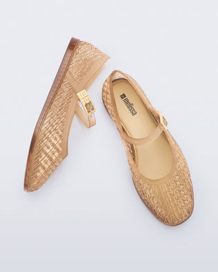 Top and side view of a pair of clear beige Harper flat with strap