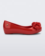 Side view of a red Ultragirl Springtime kids flat with two red flowers and peep toe.