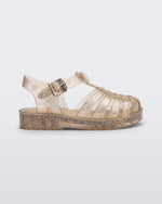 Side view of a glitter beige baby Possession sandal