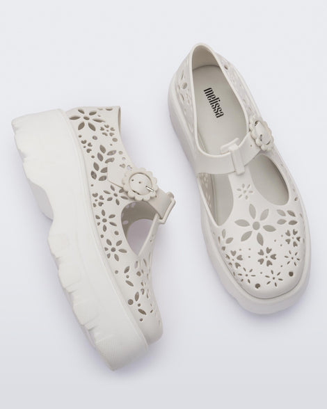 Side and top view of a pair of white Kick Off Lace women's platform shoe with buckle.