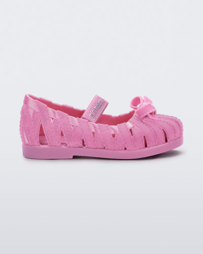 Side view of a glitter pink M Lover Ballerina baby flat with bow and strap