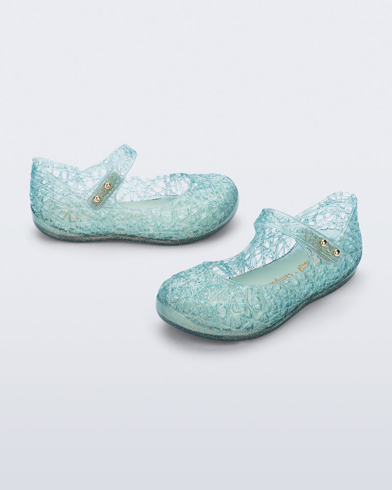 Angled view of a pair of glitter blue green Campana Zip Zag baby flats