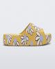 Side view of a yellow Free Print Platform slide with a white and blue flower print.