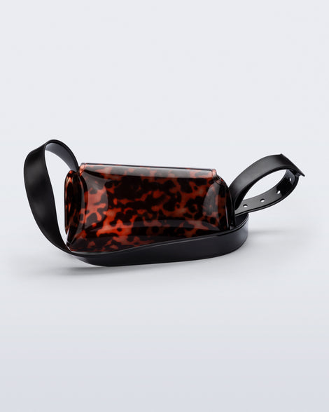 Back view of a tortoise Cross Bag with adjustable black strap