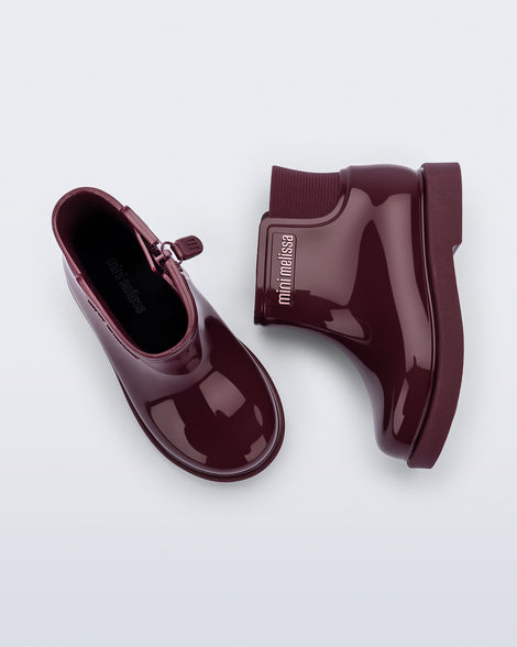 Top and side view of a pair of burgundy Chelsea II baby boots