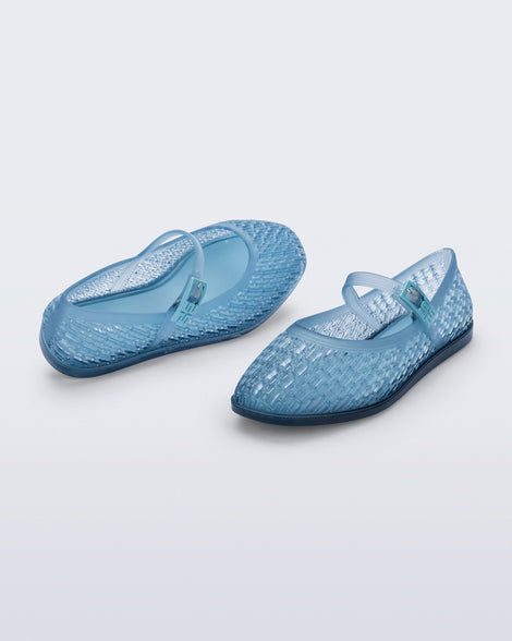 Top and angled view of a pair of transparent blue Harper flats