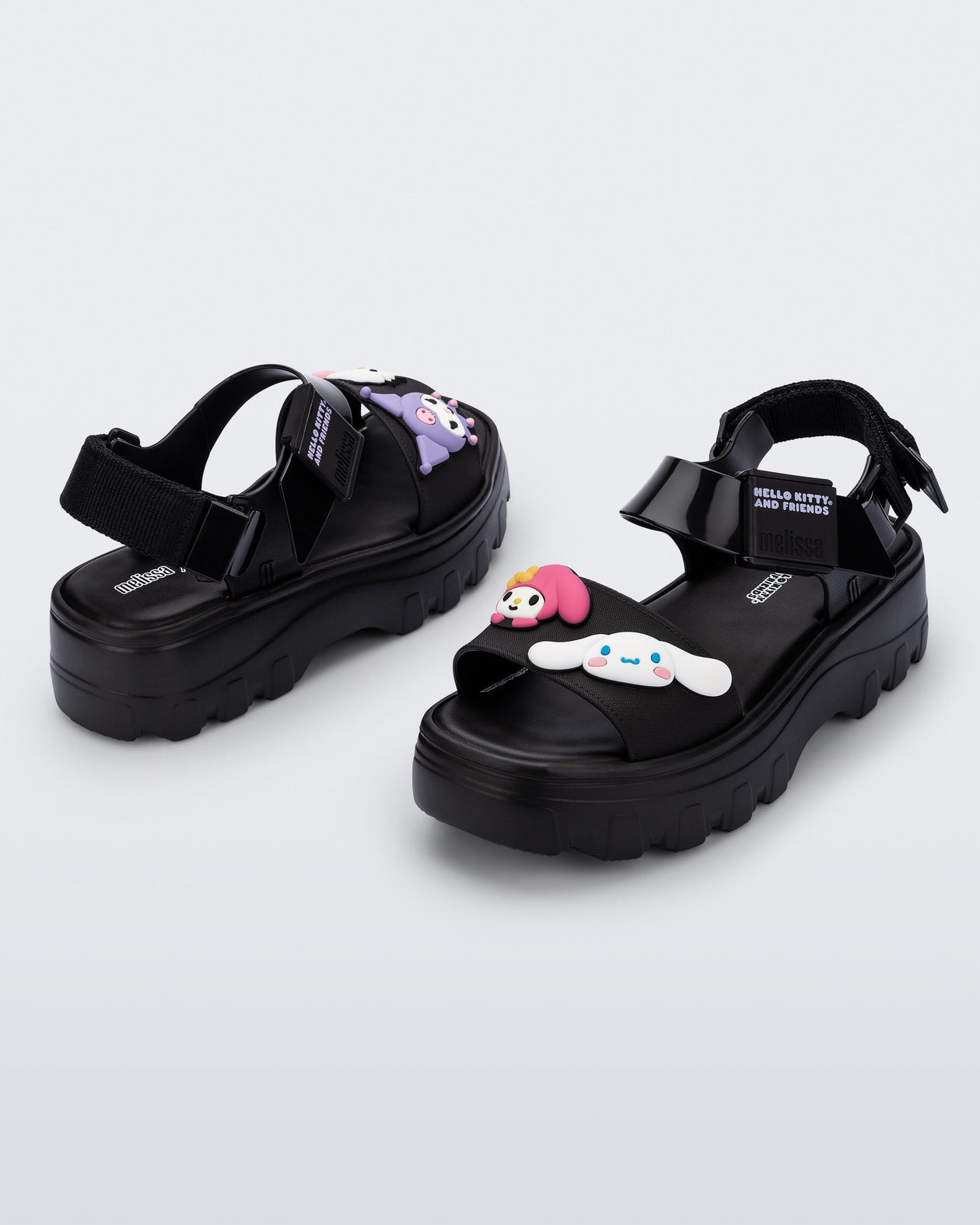 Back and angled view of a pair of black Kick Off Sandals + Hello Kitty and Friends with Hello Kitty and Friends on the upper strap