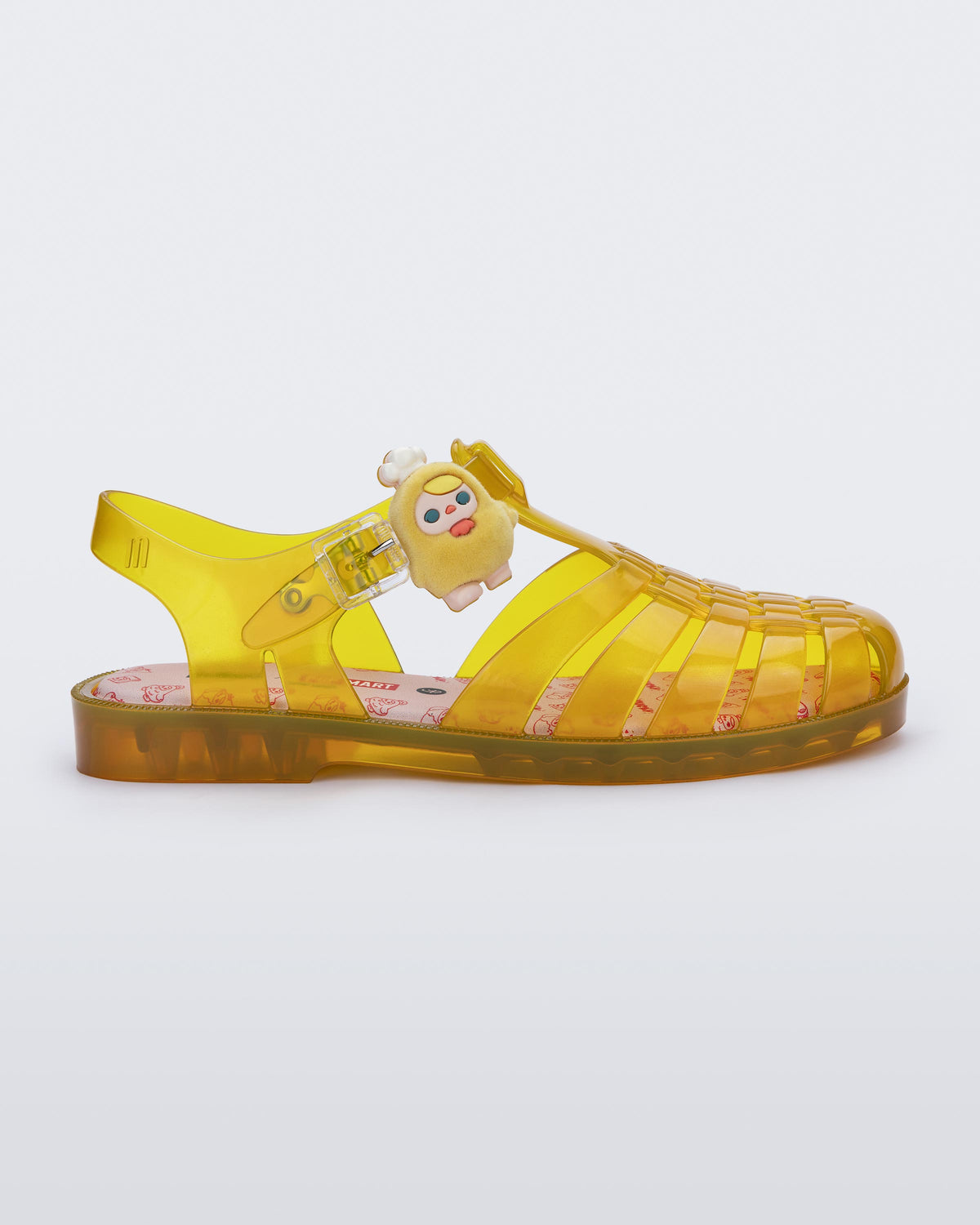Side view of a transparent yellow Possession + Pop Mart Pucky fisherman sandal