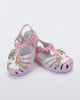 Angled view of a pair of purple/pink Possession Unicorn baby sandals with unicorn on front upper