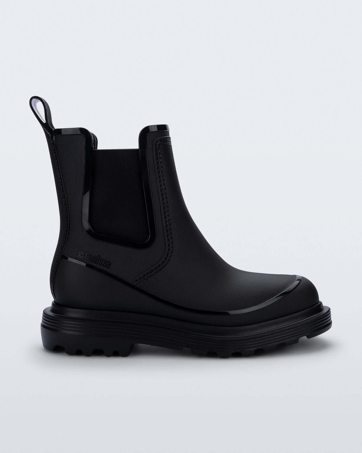 Side view of a black Noir Boot with black sole