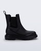 Side view of a black Noir Boot with black sole