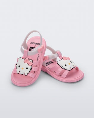 Angled view of a pair of pink Hip + Hello Kitty and Friends sandals with white ankle straps and Hello Kitty on upper