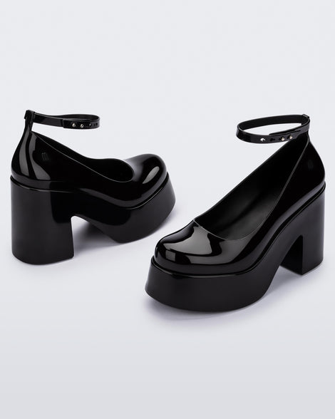 Angled view of a pair of black Melissa Doll Heel platforms with ankle strap.