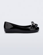 Side view of a black Sweet Love Glam kids ballerina flats with bow