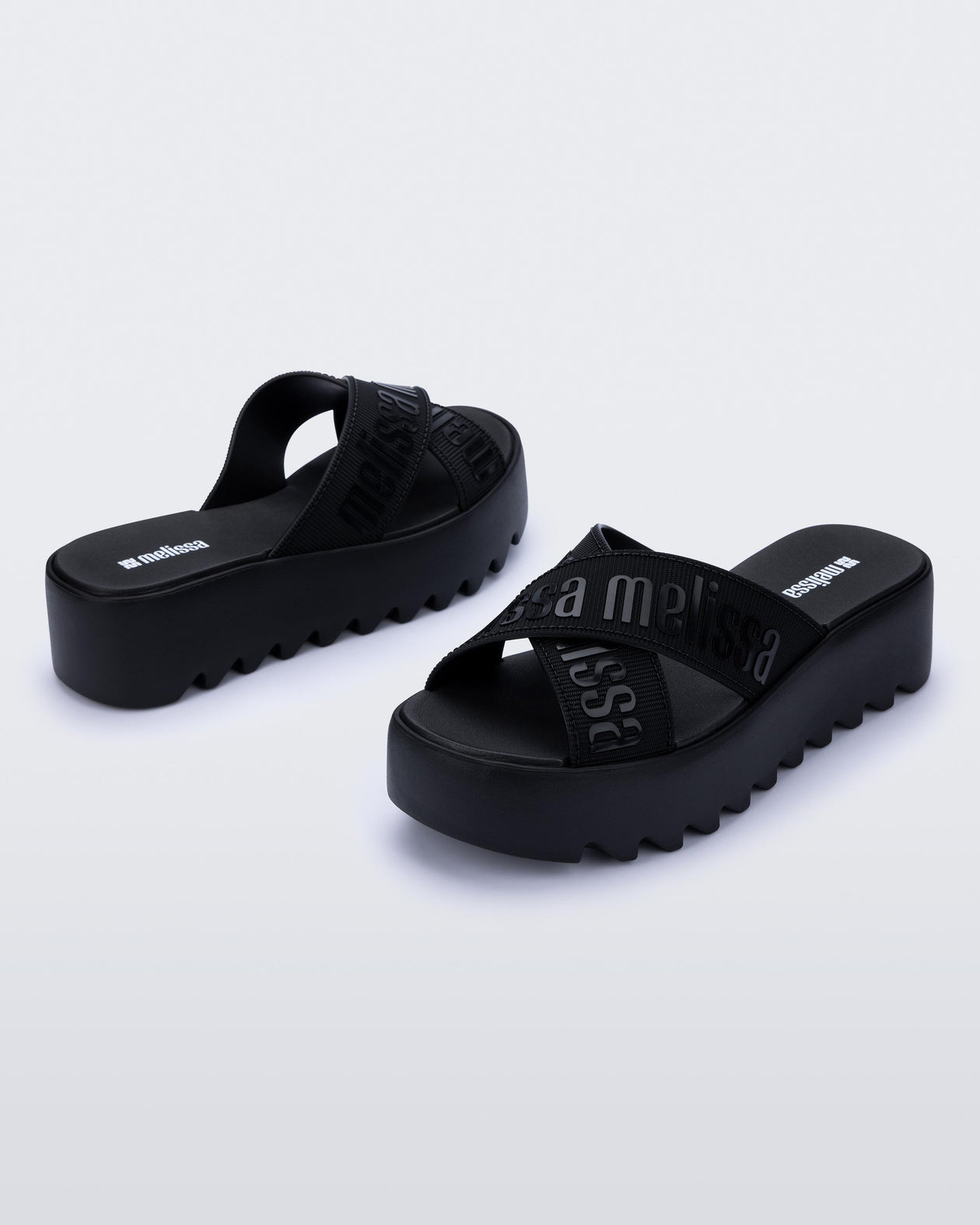 Back and side view of a pair of black M Lover Cross Strap platform slides