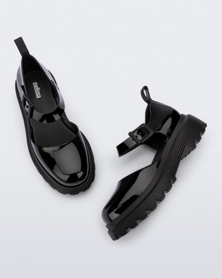 Side and top view of a pair black Ellie ankle strap loafers