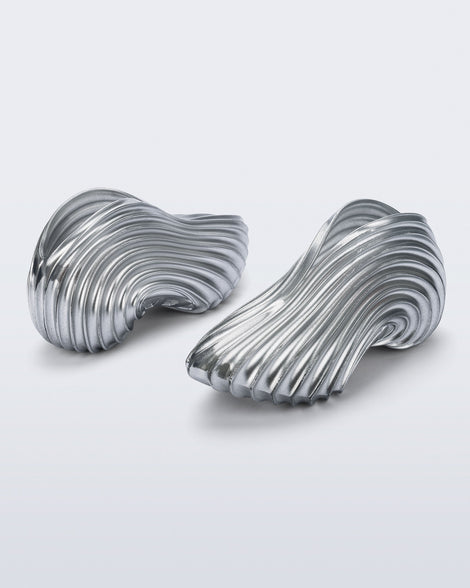Side and back angled view of a pair of silver Quantum Sneakers