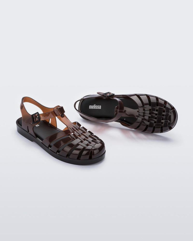 Top and angled view of a pair of clear brown Possession fisherman sandals