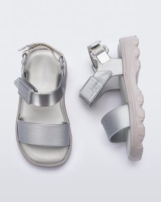 Top and side view of a pair of silver baby Kick Off Sandals