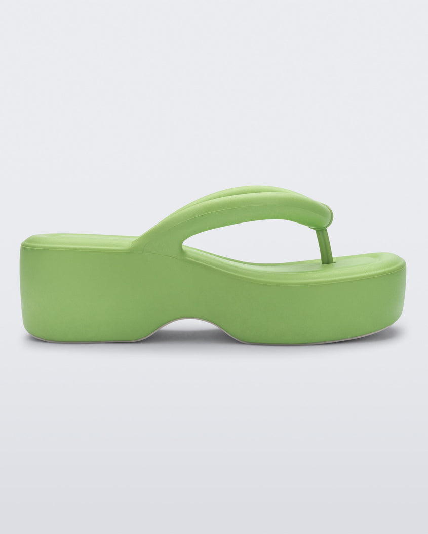 Side view of a Melissa Free platform flip flop in lime green with grey sole