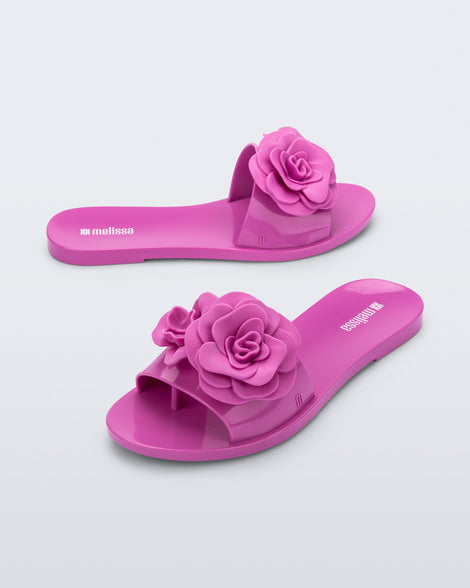 Side and angled view of a pair of pink Babe Petals slide sandals
