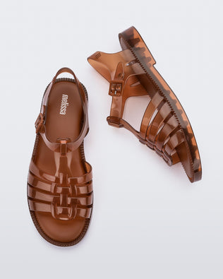 Top and side view of a pair of transparent brown Possession Fresh fisherman style sandals with open toe.