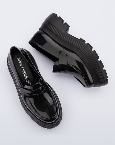 Top and side view of a pair of black Royal High + Undercover platform loafers.